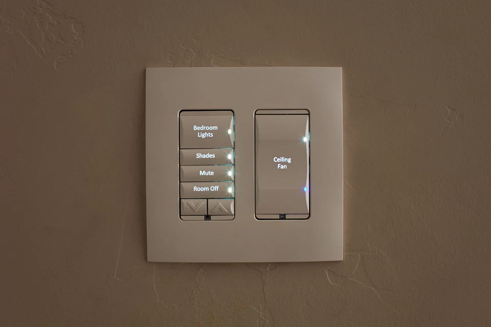 Two wall-mounted lighting control keypads with engraved buttons