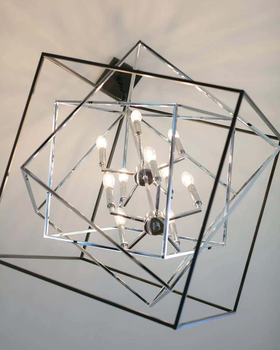 Geometric metal chandelier suspended from a white ceiling