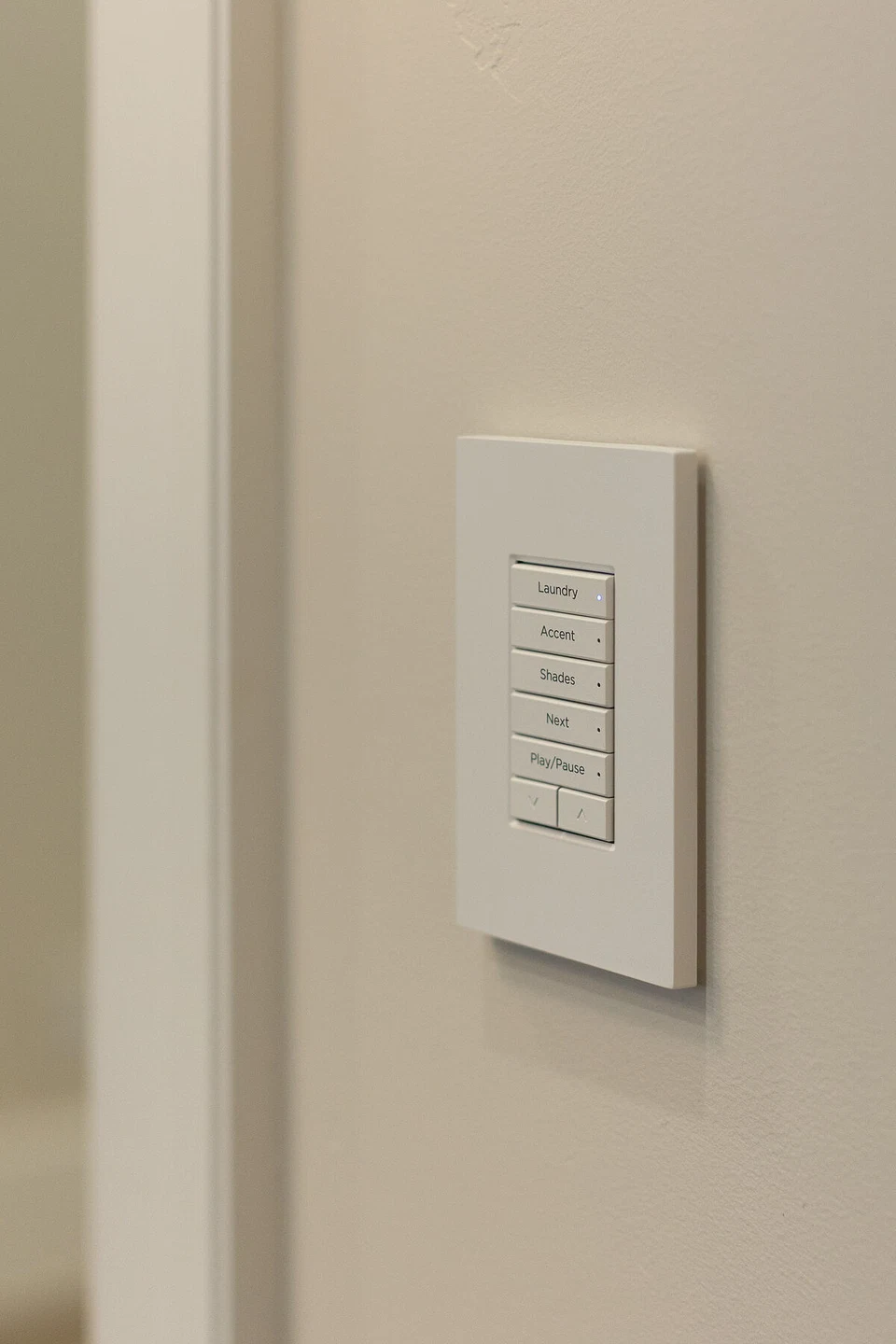 White multi-button lighting keypad beside an interior doorway