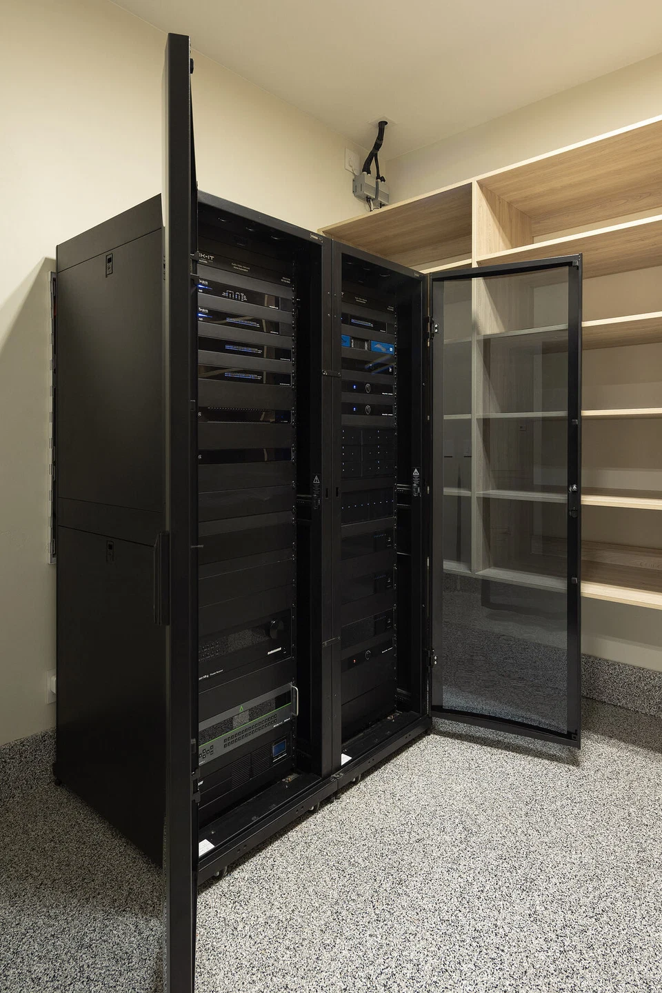 Open equipment rack door revealing stacked AV components