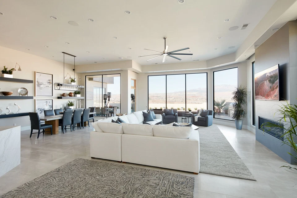 Open-plan living room and kitchen with island pendants and recessed lights