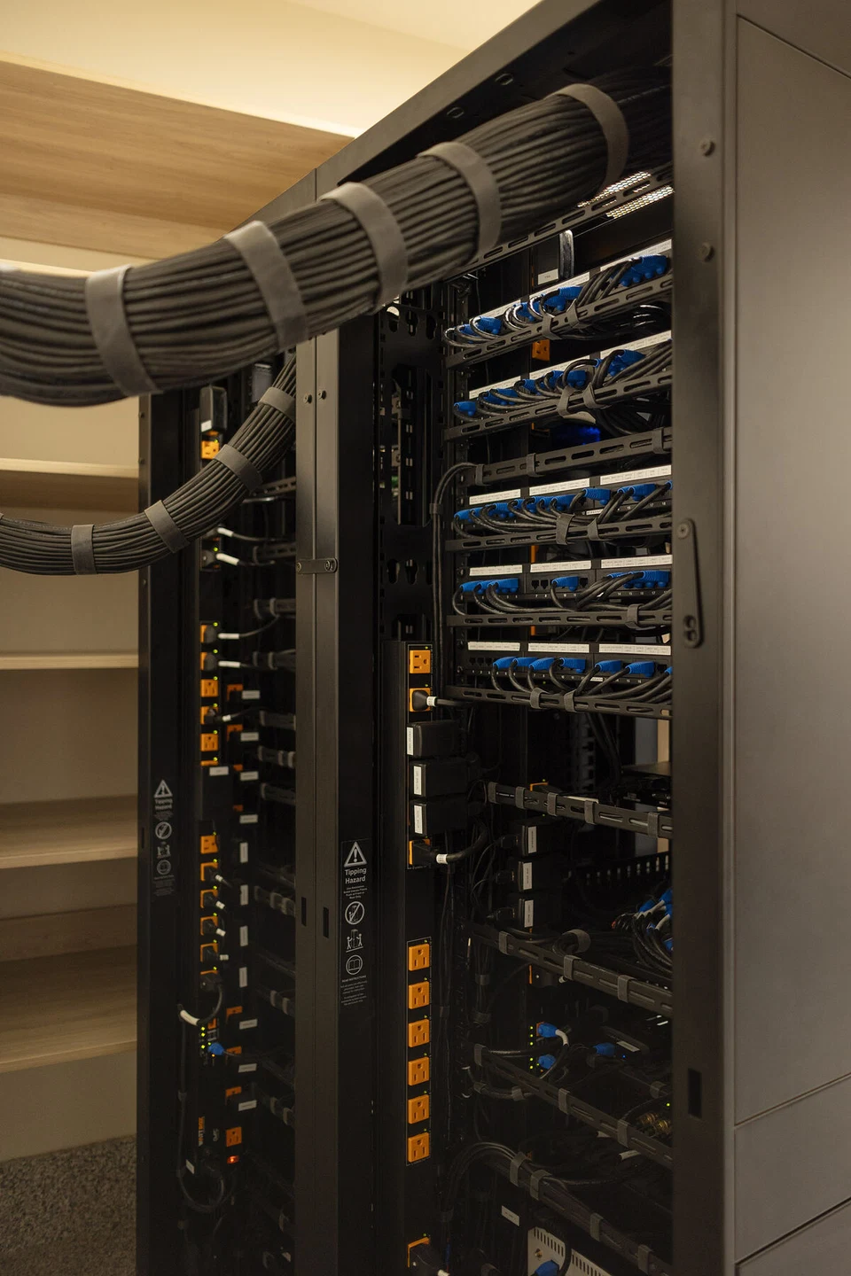 Rear of an AV equipment rack with bundled cables and connections