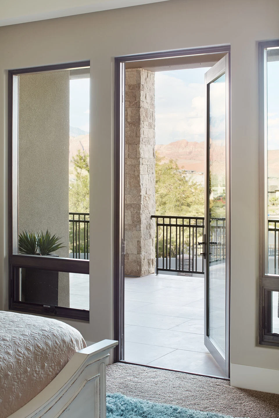 Glass bedroom door opening onto a covered balcony