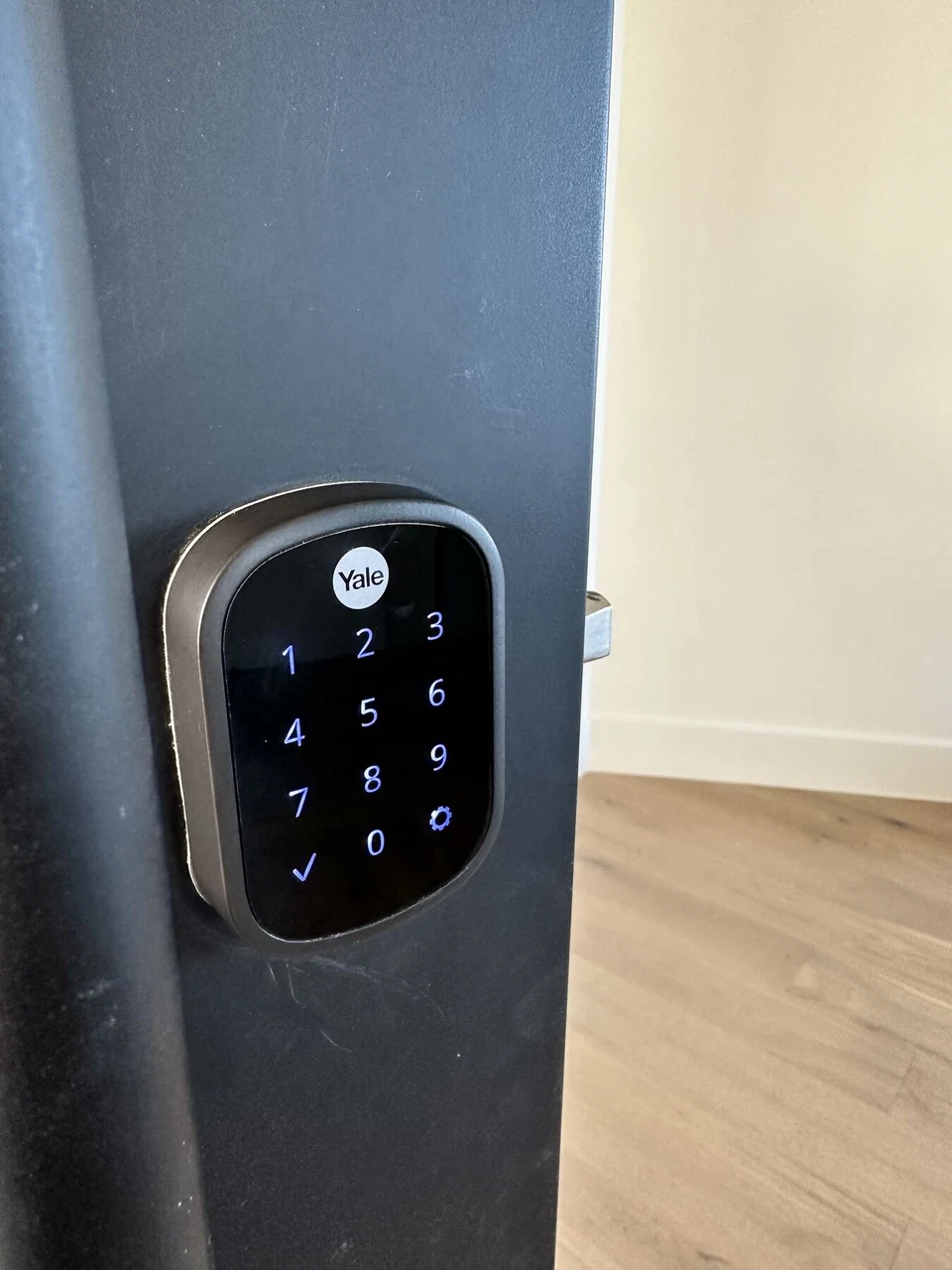 Electronic keypad deadbolt on a partially open entry door