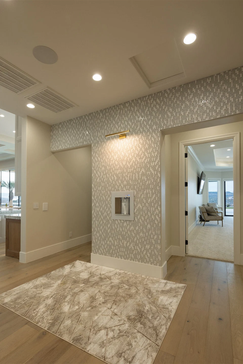 Carpeted hallway with recessed lighting and a ceiling access panel