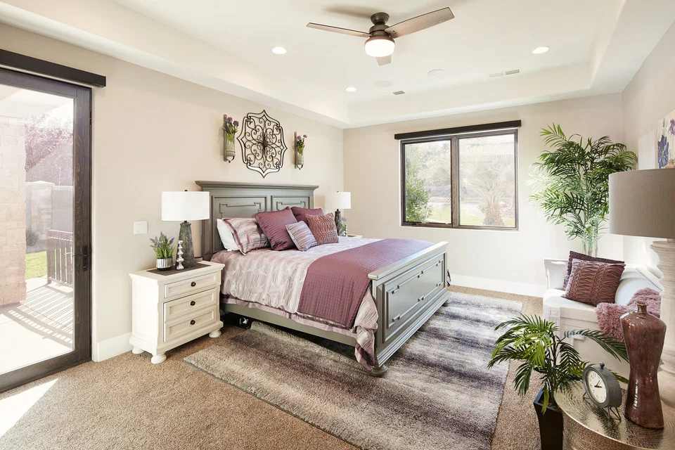 Bedroom with tray ceiling, recessed lights, and a ceiling fan