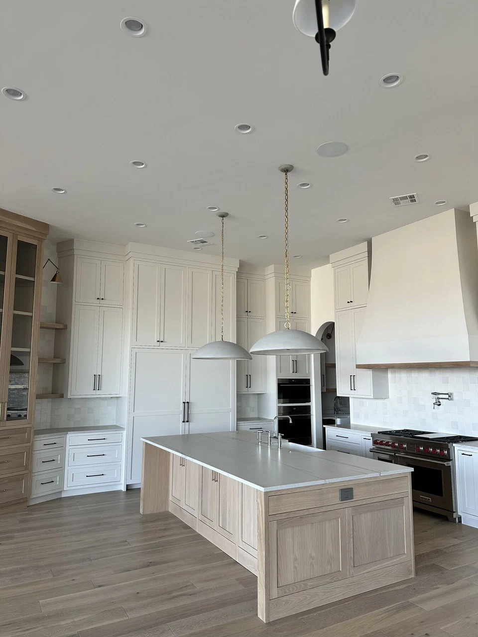 Unfurnished kitchen with white island, pendant lights, and recessed ceiling lights