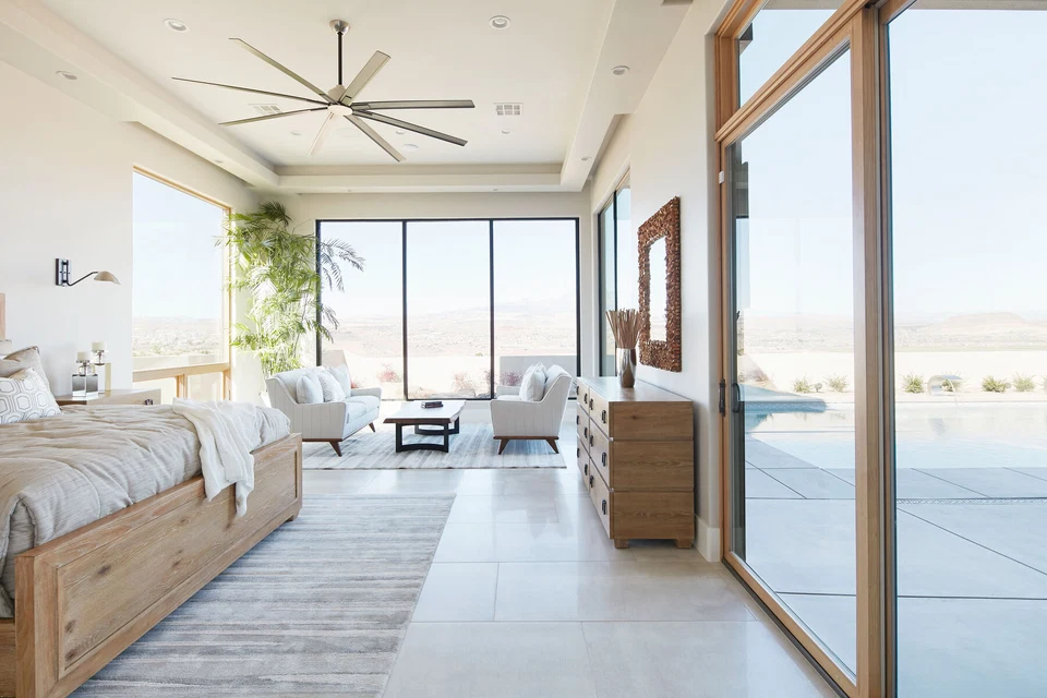 Bedroom seating area beside glass doors overlooking the pool