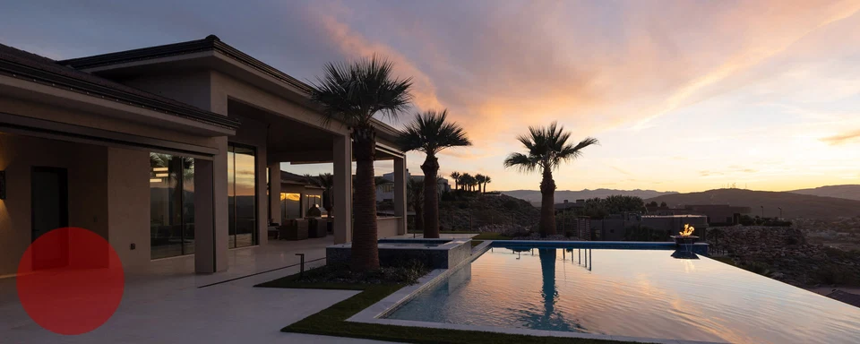 Rear patio and pool reflecting a colorful evening sky