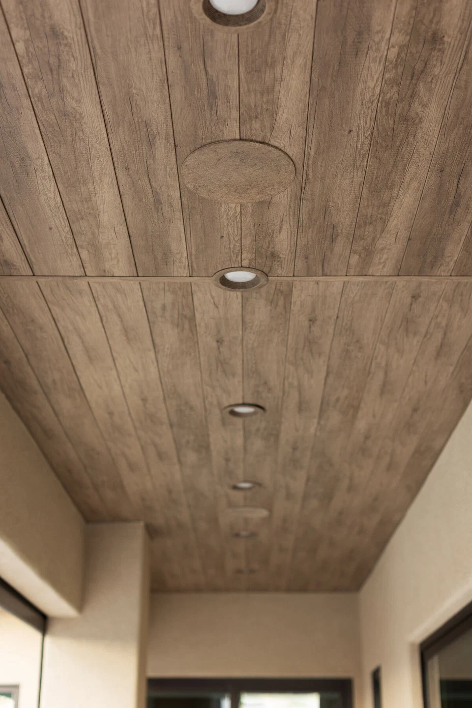 Wood patio ceiling with round recessed fixtures