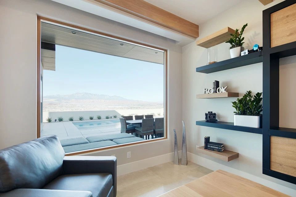 Office window overlooking the pool beside floating display shelves