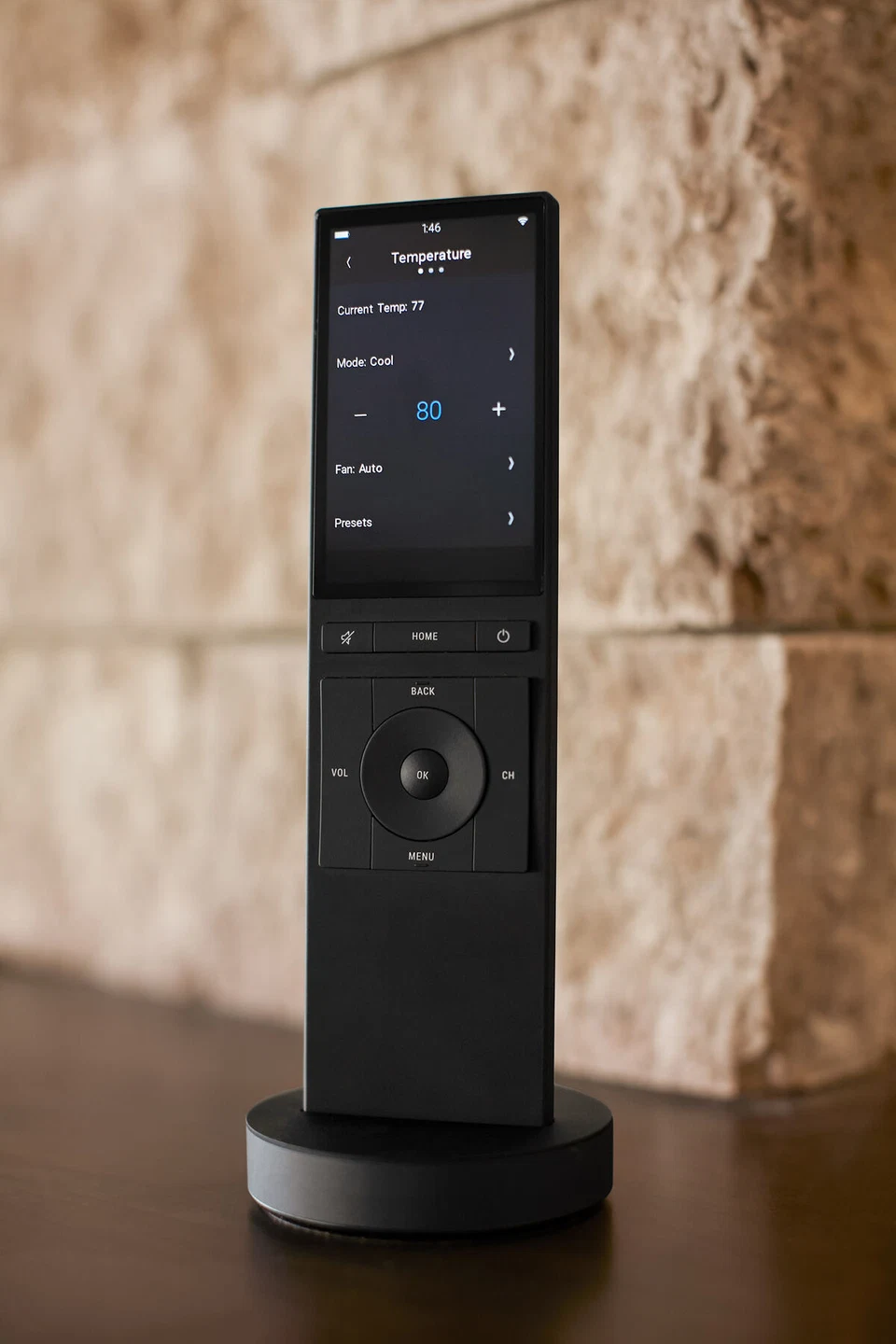 Side view of a docked touchscreen remote displaying a control list