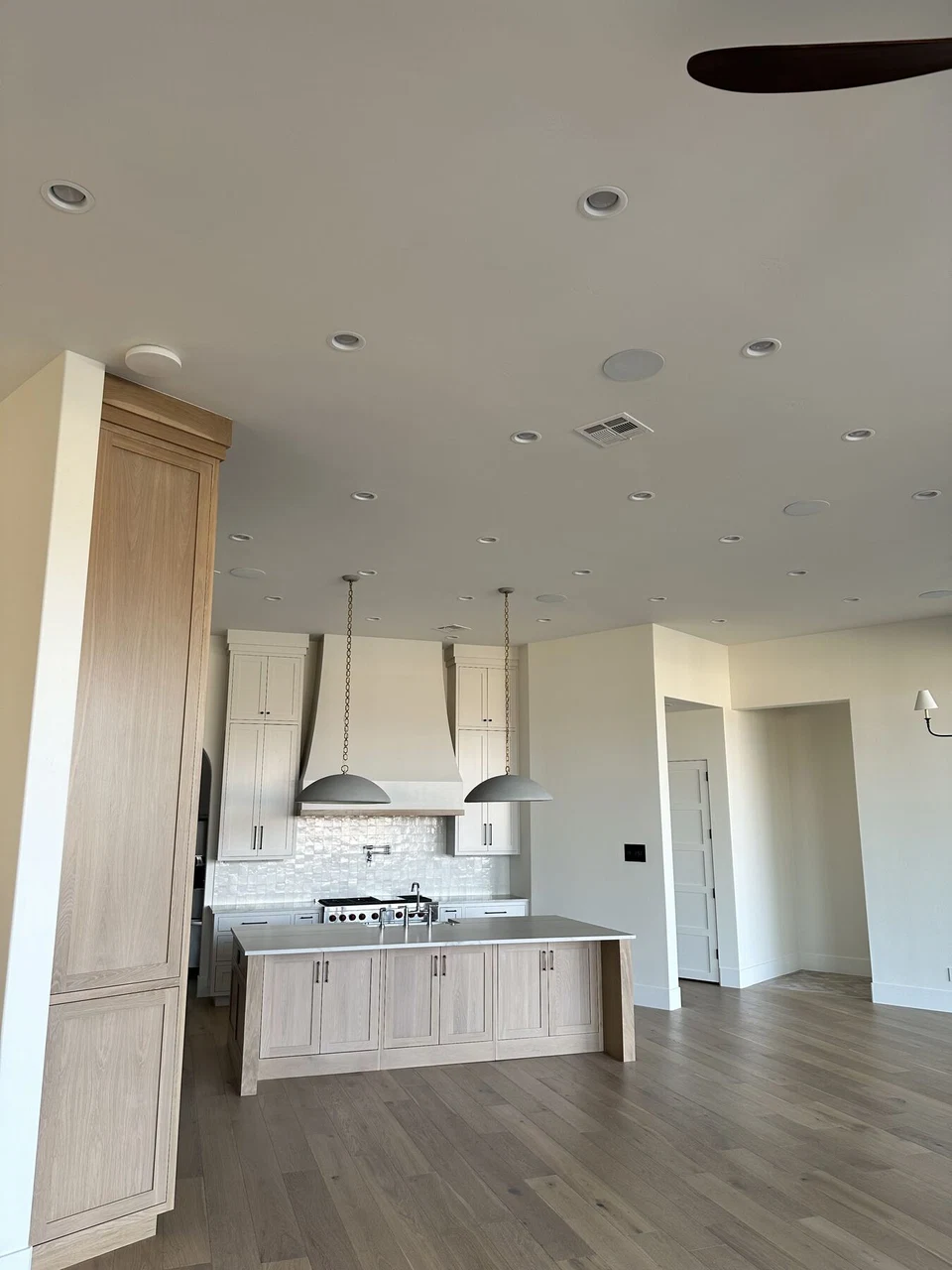 Bedroom with wood flooring and an adjoining bathroom vanity