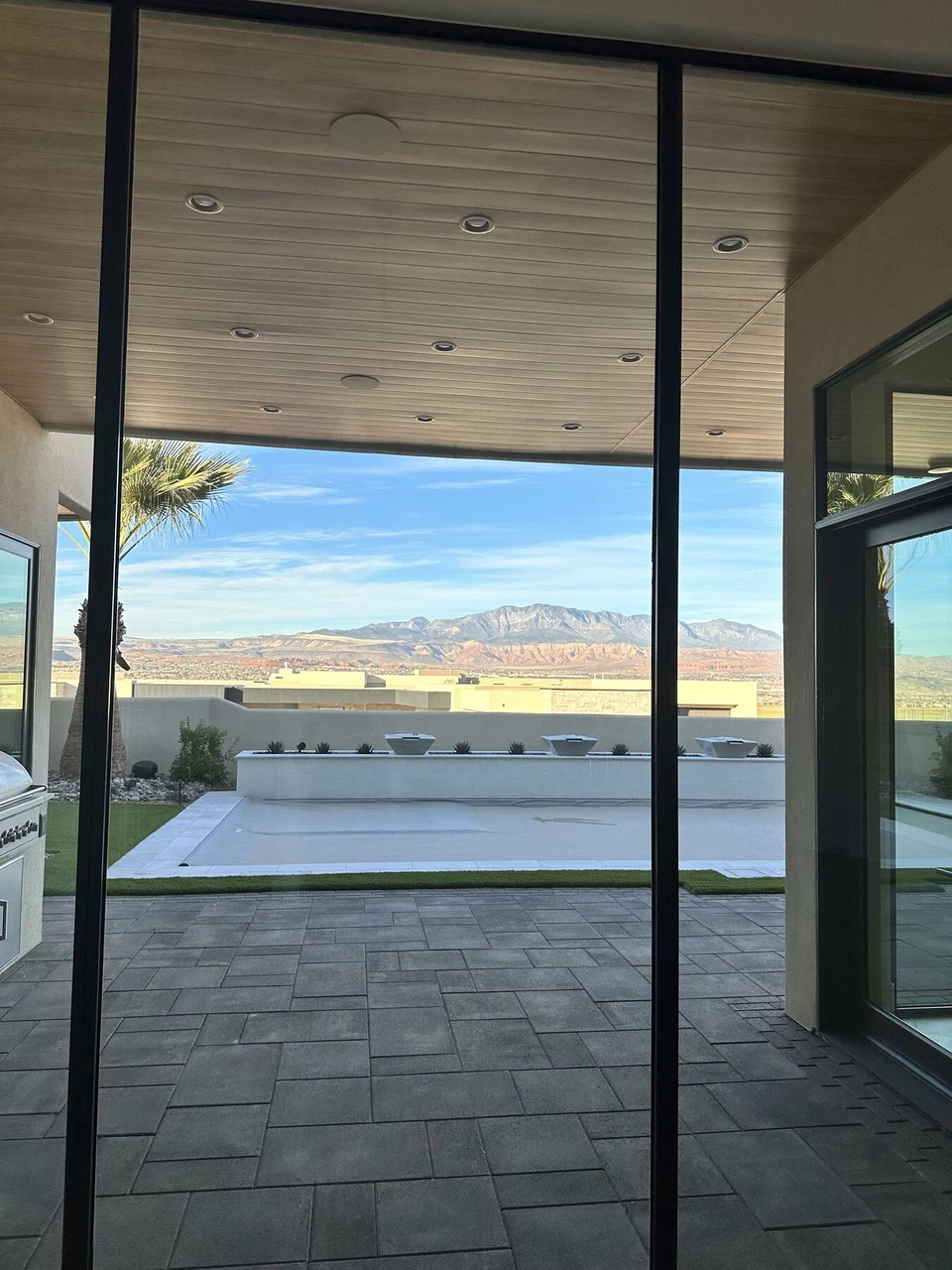 Covered patio viewed through open sliding glass doors