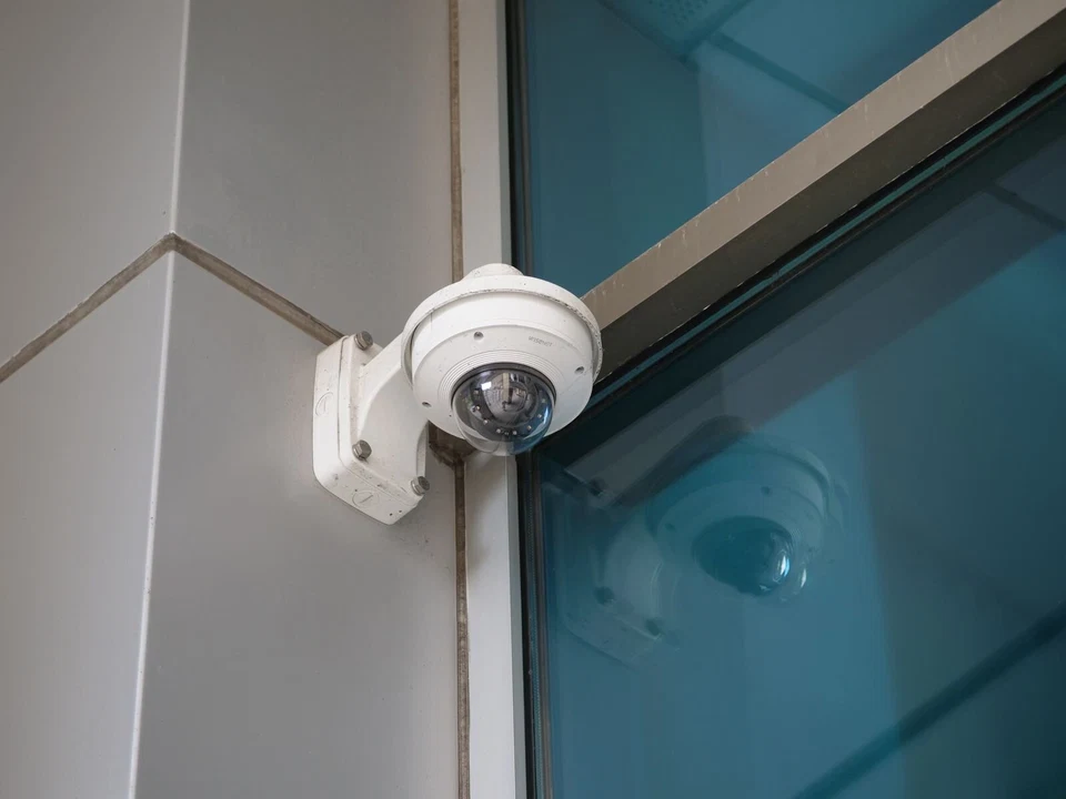Dome surveillance camera mounted outside a building