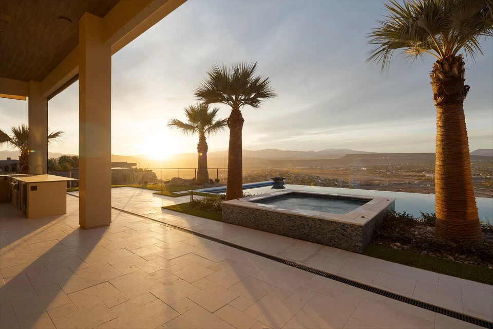 Sunset over the pool and raised spa viewed from the covered patio