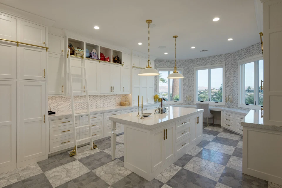 Bright secondary kitchen with island seating and white cabinetry